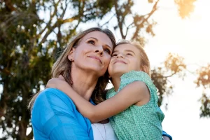 Mother is free from migraine pain and playing with her Daughter outdoors
